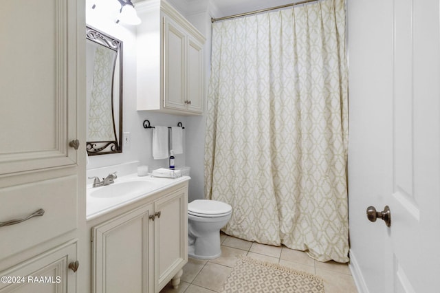 bathroom featuring tile patterned floors, vanity, and toilet