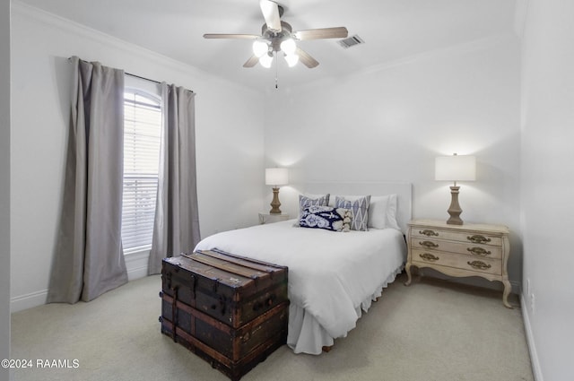 bedroom featuring light colored carpet, ceiling fan, and crown molding