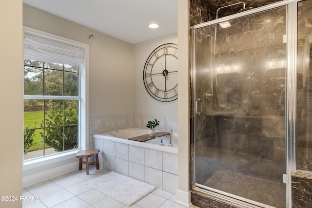 bathroom featuring tile patterned floors, a healthy amount of sunlight, and shower with separate bathtub