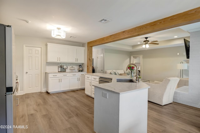 kitchen with a kitchen island with sink, white cabinets, sink, appliances with stainless steel finishes, and light hardwood / wood-style floors