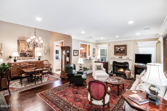 living room featuring a chandelier, dark hardwood / wood-style floors, and ornamental molding