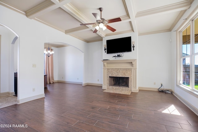 unfurnished living room featuring beamed ceiling, ceiling fan with notable chandelier, a high end fireplace, and coffered ceiling