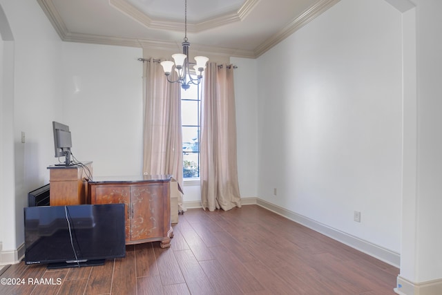 office space featuring a tray ceiling, crown molding, dark hardwood / wood-style flooring, and a notable chandelier