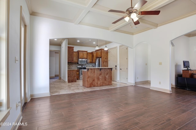 kitchen featuring a center island, coffered ceiling, a kitchen breakfast bar, beam ceiling, and stainless steel appliances