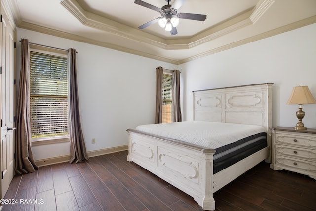 bedroom featuring a tray ceiling, ceiling fan, dark hardwood / wood-style flooring, and ornamental molding