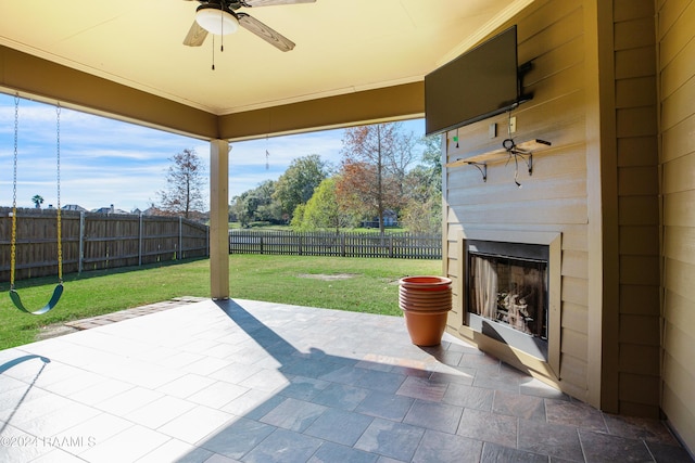 view of patio featuring exterior fireplace and ceiling fan