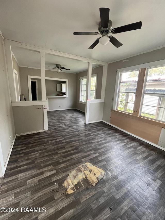 unfurnished living room featuring dark hardwood / wood-style flooring, ceiling fan, and ornamental molding