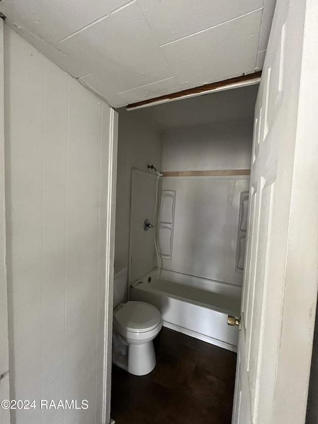 bathroom with shower / tub combination, hardwood / wood-style floors, and toilet