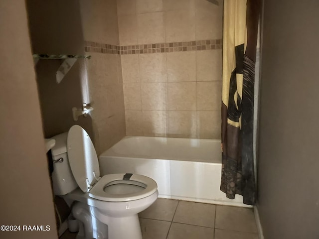 bathroom with tile patterned flooring, shower / bathtub combination with curtain, and toilet