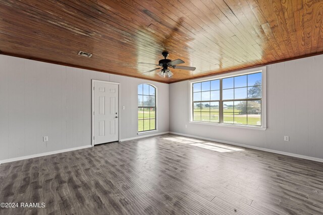 unfurnished room featuring crown molding, dark wood-type flooring, wooden ceiling, and ceiling fan