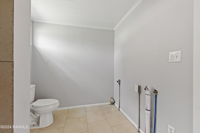 bathroom featuring tile patterned flooring, ornamental molding, and toilet