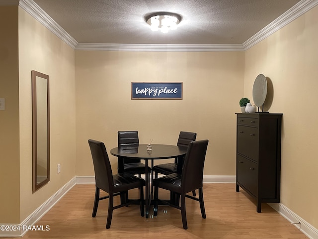 dining room featuring light hardwood / wood-style flooring and ornamental molding