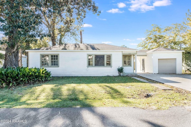 single story home featuring a garage and a front lawn