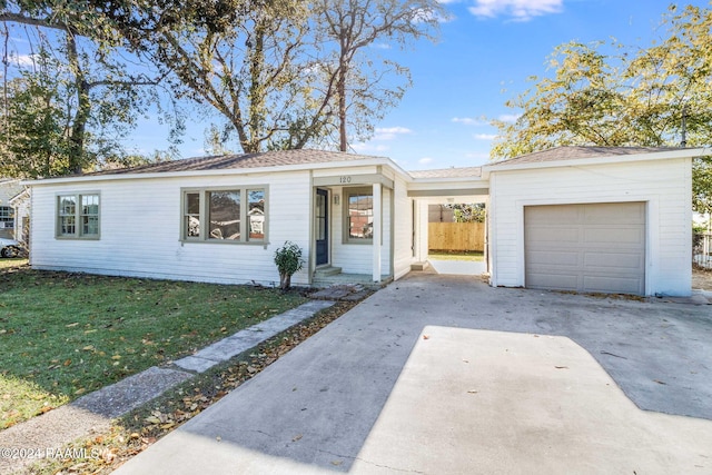 ranch-style home with a garage and a front lawn