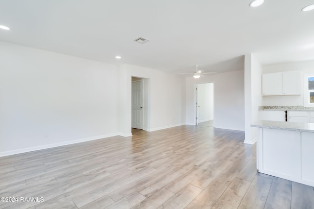 spare room featuring ceiling fan and light hardwood / wood-style floors