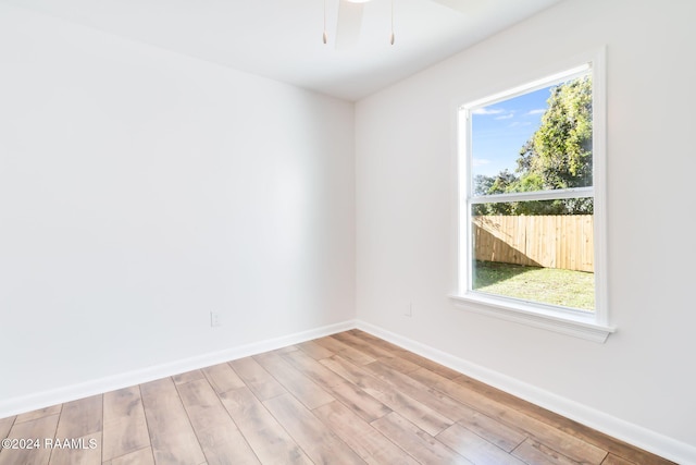 unfurnished room featuring ceiling fan, light hardwood / wood-style floors, and a wealth of natural light