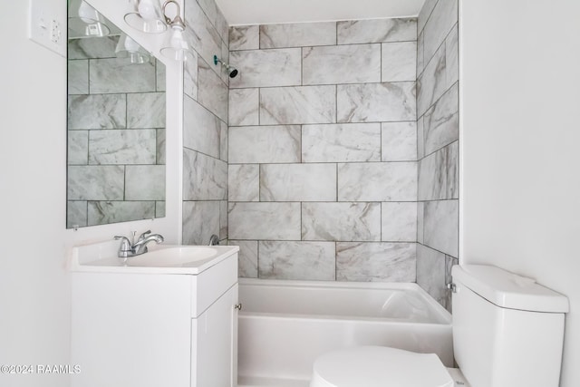 full bathroom featuring vanity, tiled shower / bath combo, and toilet