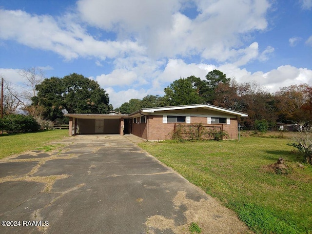 ranch-style house with a carport and a front lawn