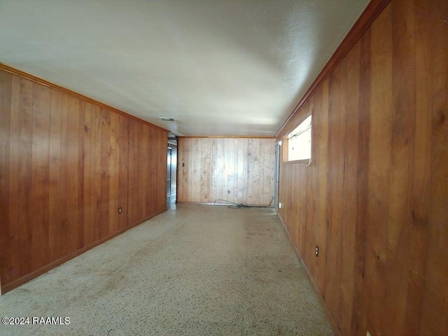 spare room with wood walls