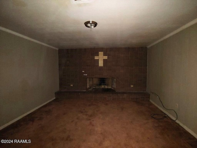 unfurnished living room featuring dark carpet, ornamental molding, and a brick fireplace