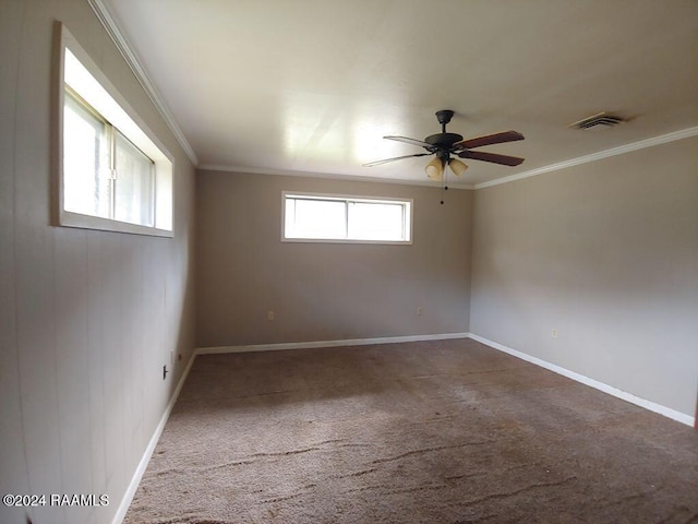 carpeted empty room with ceiling fan and crown molding