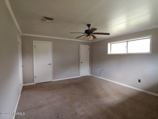 unfurnished room with light carpet, ceiling fan, and ornamental molding