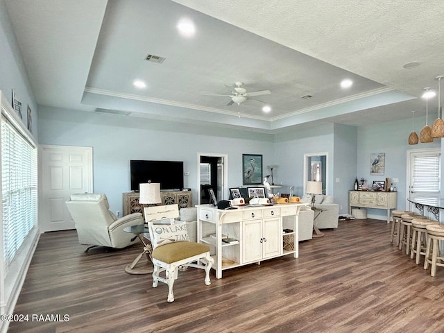 bedroom featuring a tray ceiling, dark wood-type flooring, and ornamental molding