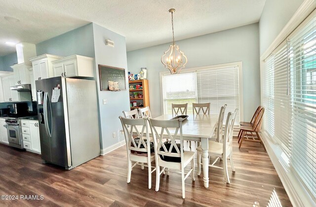 133 Lighthouse Ln, Lake Charles, LA 70607 - dining room featuring dark wood finished floors, a chandelier, and a textured ceiling