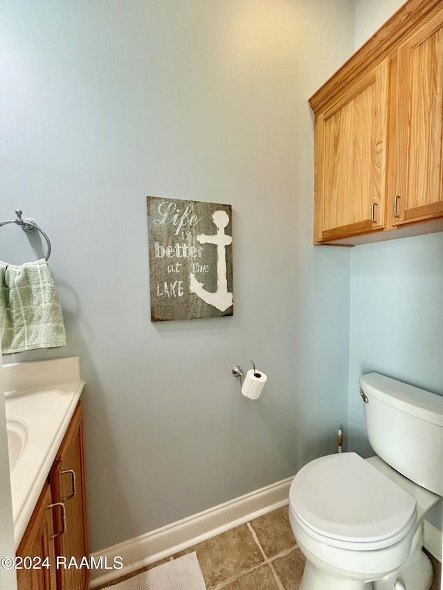 bathroom with tile patterned floors, vanity, and toilet