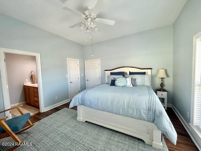 bedroom featuring connected bathroom, dark hardwood / wood-style floors, and ceiling fan