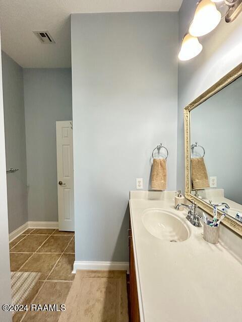 bathroom with tile patterned floors and vanity