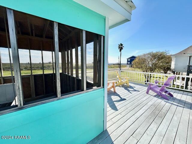133 Lighthouse Ln, Lake Charles, LA 70607 - wooden deck with a sunroom