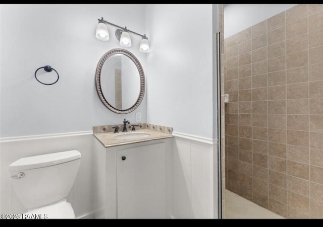 133 Lighthouse Ln, Lake Charles, LA 70607 - full bathroom featuring vanity, tiled shower, and a wainscoted wall