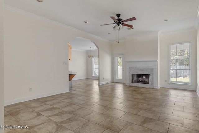 unfurnished living room with ceiling fan, light tile patterned floors, and ornamental molding