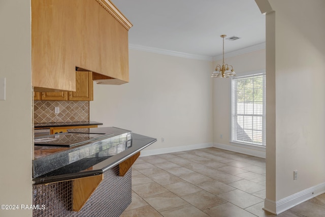 kitchen featuring tasteful backsplash, crown molding, light tile patterned floors, and a notable chandelier