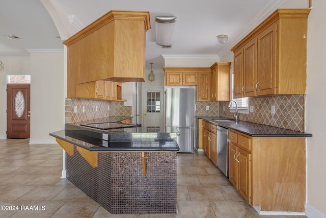 kitchen featuring a kitchen breakfast bar, sink, ornamental molding, kitchen peninsula, and stainless steel appliances