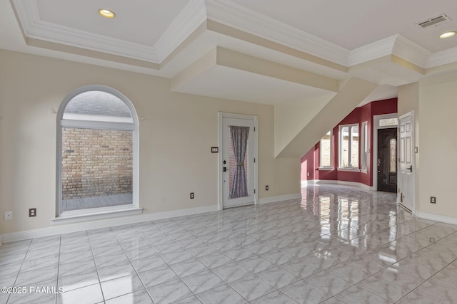 interior space with a tray ceiling and crown molding