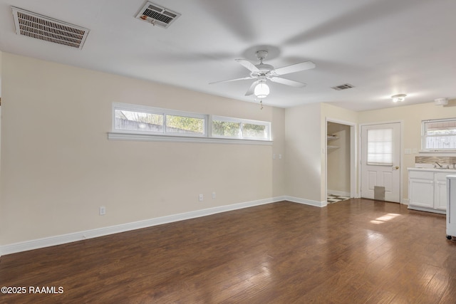 interior space with ceiling fan, a healthy amount of sunlight, dark hardwood / wood-style flooring, and sink