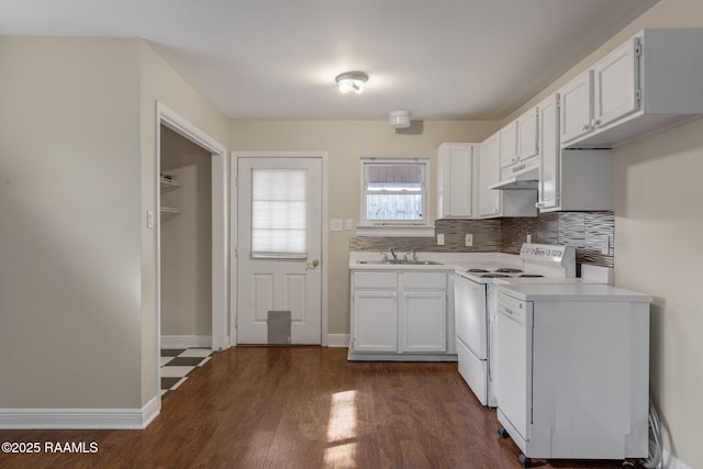 kitchen featuring tasteful backsplash, sink, dark wood-type flooring, white electric stove, and white cabinets