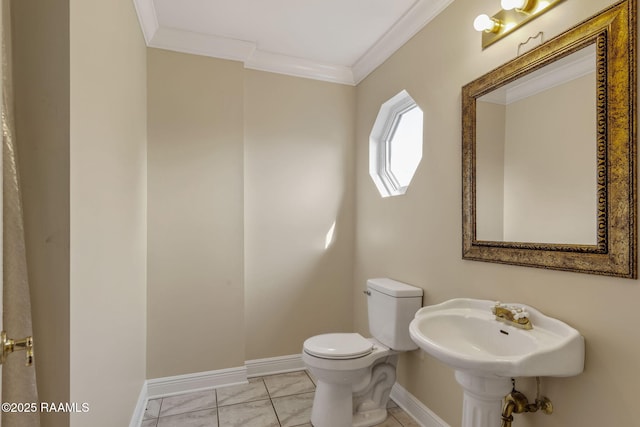 bathroom with toilet, crown molding, and tile patterned floors