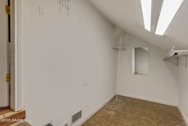 spacious closet with vaulted ceiling and electric panel