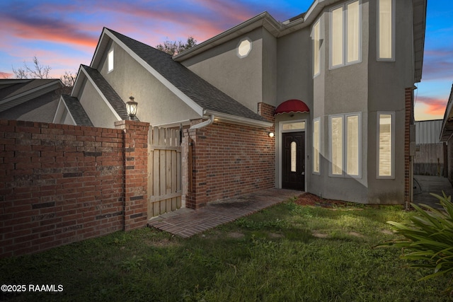 111 Georgetown Loop, Lafayette, LA 70506 - rear view of house with a lawn, a gate, stucco siding, and fence