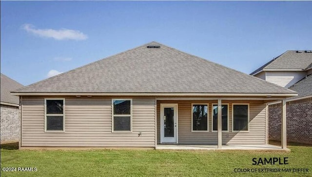 rear view of house featuring a yard