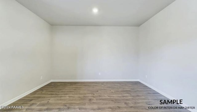 spare room featuring wood-type flooring