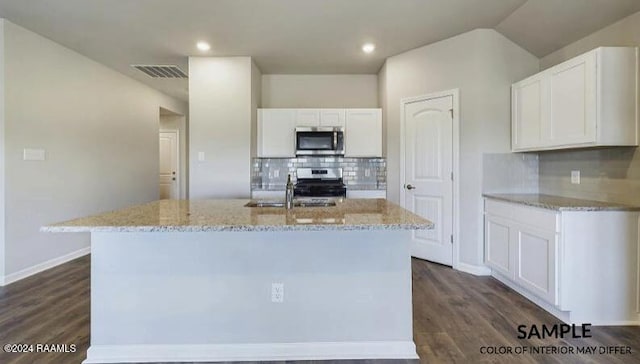 kitchen with backsplash, stainless steel appliances, a kitchen island with sink, dark hardwood / wood-style floors, and white cabinetry