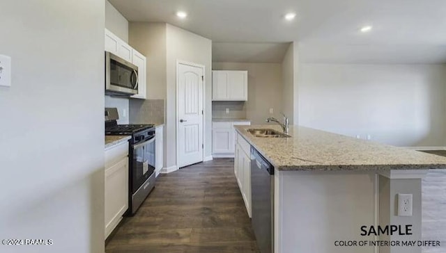 kitchen featuring appliances with stainless steel finishes, sink, a center island with sink, dark hardwood / wood-style floors, and white cabinetry