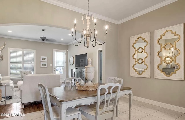 tiled dining room with ceiling fan and crown molding