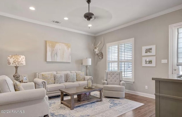 living room featuring hardwood / wood-style floors, ceiling fan, and crown molding