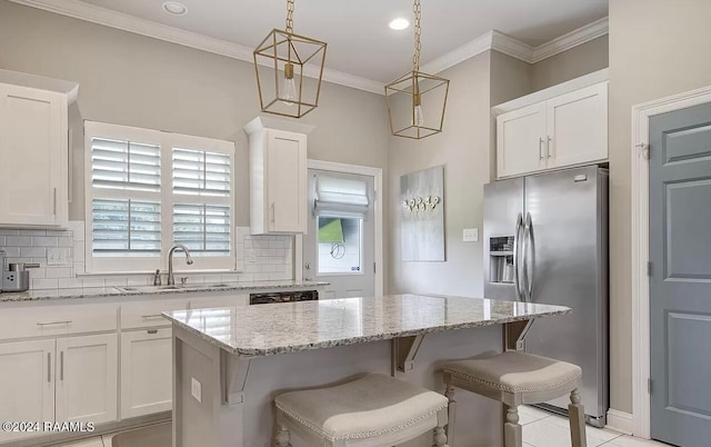 kitchen featuring a center island, white cabinetry, stainless steel fridge with ice dispenser, and sink