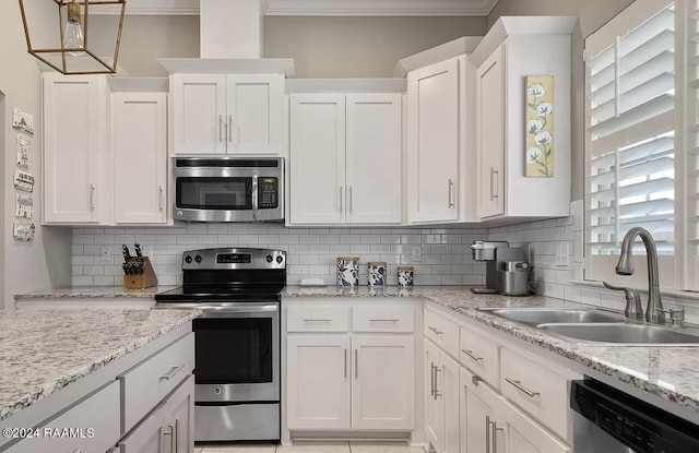 kitchen featuring decorative backsplash, appliances with stainless steel finishes, ornamental molding, sink, and white cabinetry